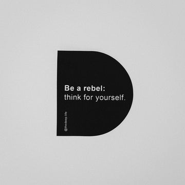 Sticker in the shape of a D that reads: Be a rebel: think for yourself